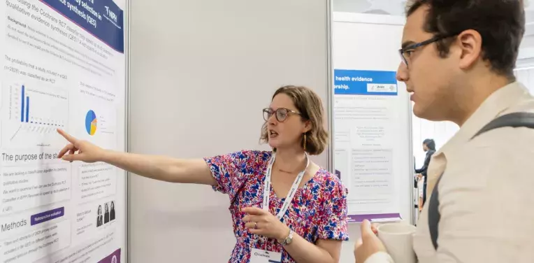 Researchers discussing research poster