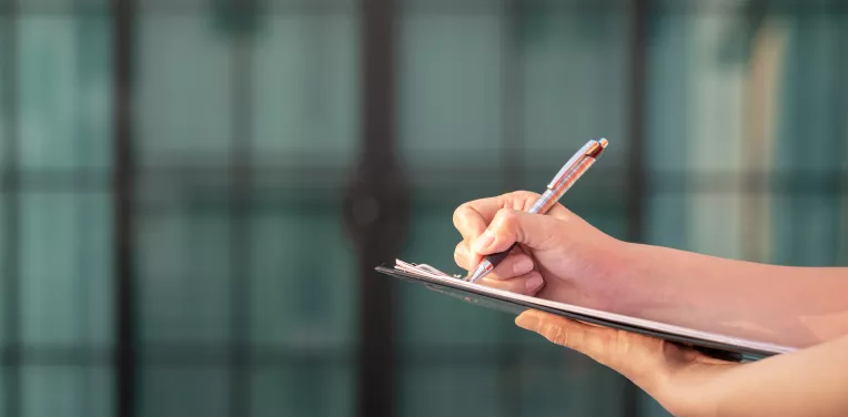 Hands holding a clipboard