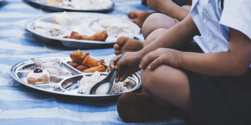 children sitting in front of plates of food