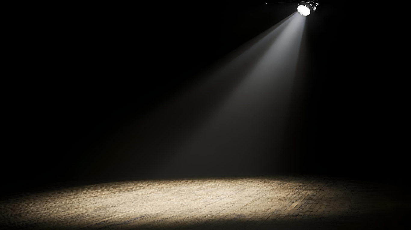 A spotlight shines on an empty stage